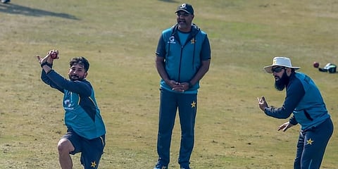 Pakistan's Yasir Shah (L) bowls as team head coach Misbah ul-Haq (R) and bowling coach Waqar Younis (C) look on during a practice session at the Rawalpindi. (File Photo | AFP)
