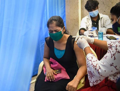 A medical staffer inoculates a beneficiary with a dose of Covid-19 vaccine. (Photo | PTI)