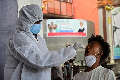 A medic collects swab sample from a person. (Photo | Ashishkrishna HP, EPS)