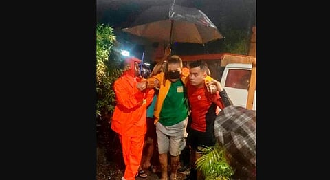 In this photo provided by the Philippine Coast Guard, a man is evacuated to safer ground after floodwaters continued to rise due to typhoon at Ormoc City. (Photo | AP)