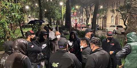 People gather outside on the sidewalk after a strong earthquake was felt, in the Roma neighborhood of Mexico City, Tuesday, Sept. 7, 2021. (Photo | AP)