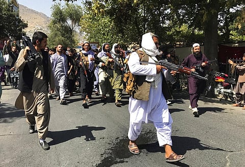 Taliban soldiers walk towards Afghans shouting slogans, during an anti-Pakistan demonstration, near the Pakistan embassy in Kabul. (Photo | AP)