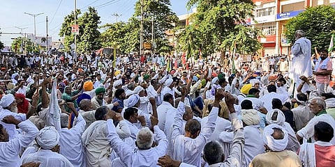 Farmers during their sit-in protest after their Kisan Mahapanchayat, outside the Mini Secretariat in Karnal. (Photo | PTI)