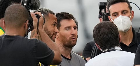 Argentina's Lionel Messi, center, Brazil's Neymar, left, and Argentina's coach Lionel Scaloni talk as the football game is interrupted by Brazilian health authorities. (Photo | AP)