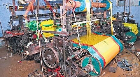 A weaving machine lies covered in mud, at one of the units that was inundated by floodwater during incessant rains in Rajanna-Sircilla district, on Wednesday