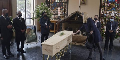 A mourner touches the coffin of Anglican Archbishop Emeritus Desmond Tutu during his funeral at the St. George's Cathedral in Cape Town, South Africa (Photo | AP)