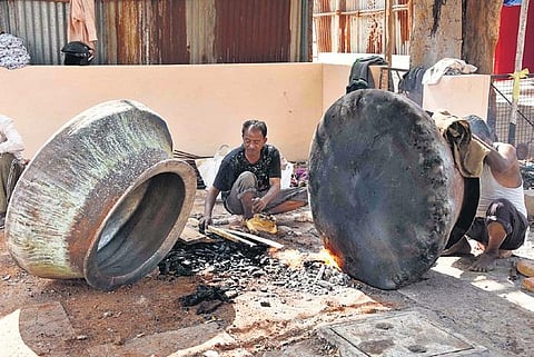 Workers clean metal vessels, used for making haleem, in preparation for the All India Industrial Exhibition, popularly known as Numaish, on Friday, Dec 31, 2021. (Photo | EPS, RVK Rao)