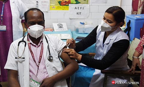  A health worker administers a booster dose of COVID-19 vaccine to a beneficiary in New Delhi on Monday.  (Photo | Shekhar Yadav, EPS)