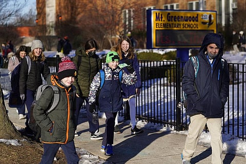 Students at the Mt. Greenwood Elementary School in Chicago depart after a full day of classes Monday, Jan. 10, 2022. (Photo | AP)
