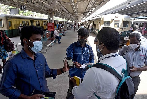A staff checks passengers’ vaccination certificates at Central station. (Photo | R Satish Babu, EPS)
