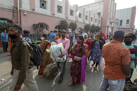 Passengers wearing face masks as a precaution against coronavirus arrive at a railway station in Hyderabad. (Photo | AP)