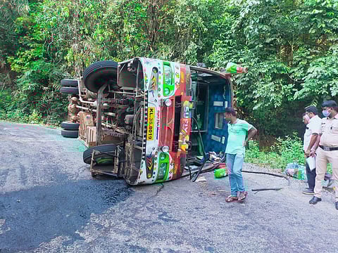 The bus that toppled after the accident in Kollur on Tuesday (Photo | Special arrangement)
