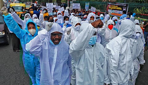 The members of the All Kerala Covid Brigade Association took out a protest march demanding risk allowance and experience certificates as part of the indefinite day and night strike.