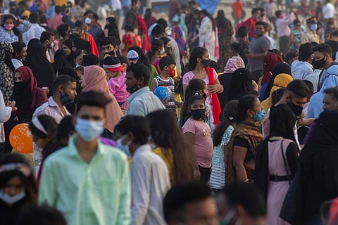 People, mostly wearing face masks to help curb the spread of the coronavirus, at Mumbai's Juhu beach. (File Photo | AP)