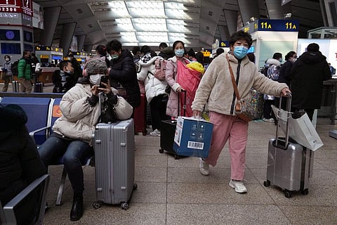 Passengers wearing mask to protect from the coronavirus wait for their train at the South Train Station in Beijing, China, Friday, Jan. 14, 2022. (Photo | AP)