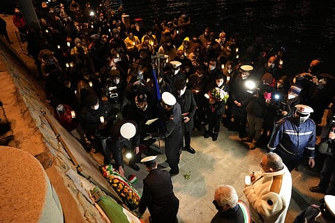 Coastguard members place flowers on a memorial stone unveiled on the 10th anniversary of the Costa Concordia cruise ship disaster, in the Tuscan island of Isola del Giglio, Italy. (Photo | AP)