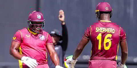 West Indies' bowler Romario Shepherd (R) chats with a teammate during the 2nd ODI against Ireland. (Photo| Twitter)