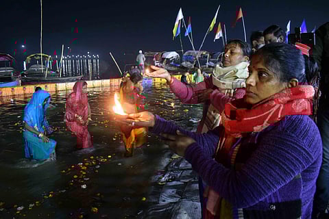 Devotees gather on the banks of Ganga river to take a 'holy dip' on the occasion of 'Makar Sankranti' during the ongoing 'Magh Mela' festival at Sangam in.Prayagraj, Friday. (Photo | PTI)
