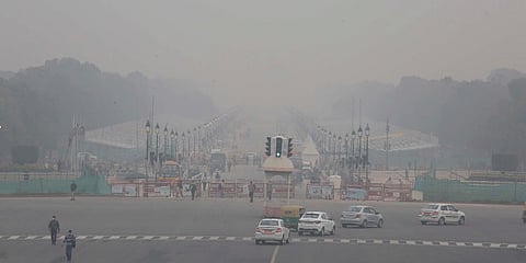 Vehicles ply at Rajpath amid low visibility due to fog, in New Delhi. (Photo| Shekhar Yadav, EPS)