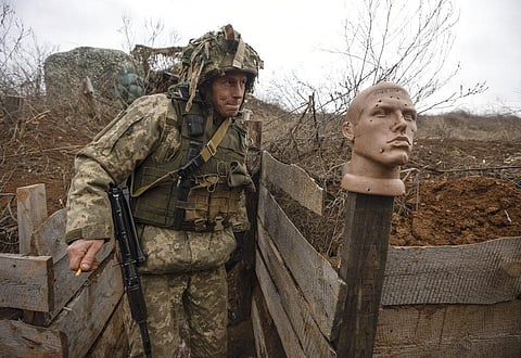 A Ukrainian soldier walks in a trench at the line of separation from pro-Russian rebels, in the Donetsk region, Ukraine, Sunday, Jan. 9, 2022. (Photo | AP)