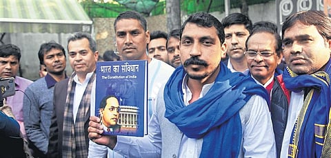 Bhim Army chief Chandrasekhar Azad holds a copy of the Constitution. (File Photo| Express)