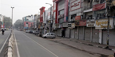 Shops are seen closed at Central Market during a weekend curfew in New Delhi. (Photo| ANI)
