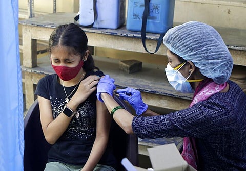 A teenager receives her first dose of vaccine for COVID-19 at a college in Mumbai, India, Saturday, Jan. 15, 2022. (Photo | AP)