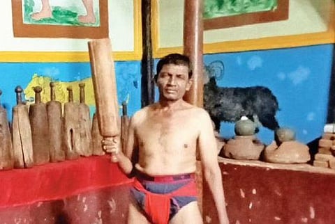 Ishappa Bangari, a pahelwan from Hanaman Garadi (below), wields a gaja during a workout routine | EXPRESS
