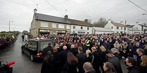 Ashling Murphy's family and mourners walk behind the hearse as it leaves St. Brigid's Church, Mountbolus, Co Offaly, Ireland, Tuesday, Jan. 18, 2022 at the end of her funeral (Photo | AP)