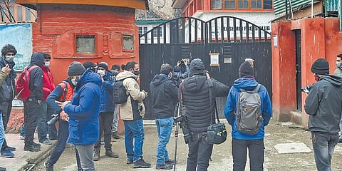 Media personnel outside Kashmir Press Club after the government takeover. (Photo | PTI)