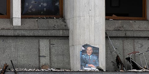 FILE - A portrait of former President Nursultan Nazarbayev at the city hall building after clashes in the central square blocked by Kazakhstan troops and police in Almaty, Jan 10, 2022. (Photo | AP)
