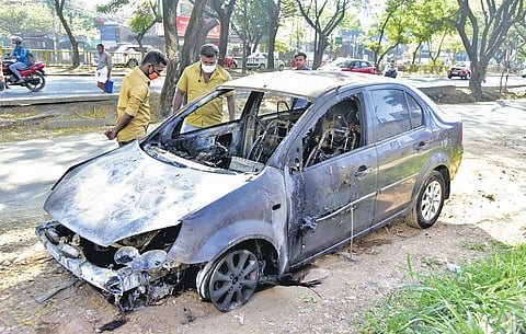 People look at the Ford Classic car that caught fire while on the move at Chalikkavattom near Vyttila on Saturday morning | A Sanesh