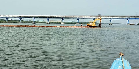The road, being allegedly built by dumping tonnes of debris and dredged sea sand, is coming up where floodwaters from Thiruvottiyur, Manali and Ponneri taluk enter the sea.