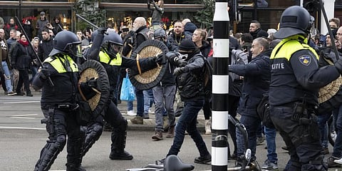 Police clash with demonstrators as  people defied a ban Sunday to gather and protest the government's coronavirus lockdown measures, in Amsterdam. (Photo | AP)