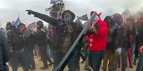 This image, from the criminal complaint, shows a Brian Christopher Mock, center, in an image captured in police body-worn video on the West Front of the U.S. Capitol in Washington. (Photo | AP)