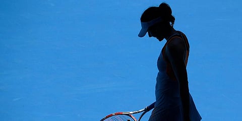 Alize Cornet of France prepares to receive serve from Simona Halep of Romania during their fourth round match at the Australian Open in Melbourne, Australia, Jan 24, 2022. (Photo | AP)