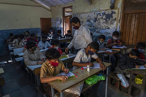 Students wearing masks attend classes at a school in Dharavi, one of Asia's largest slums,Mumbai, India, Monday, Jan. 24, 2022. (Photo | AP)