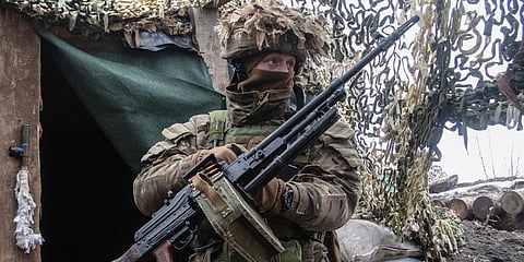 An Ukrainian soldier stands at the line of separation from pro-Russian rebels, Donetsk region. (Photo | AP)