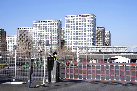 A guard stands at an entrance to the Olympics Village where athletes will stay for the Beijing Olympics in Beijing. (Photo | AP)