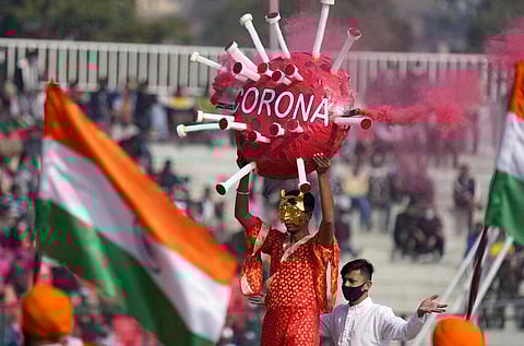 School children perform with a model of the coronavirus during India's Republic Day celebrations in Jammu. (Photo | AP)