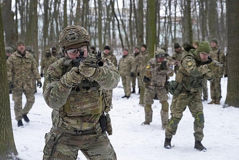 Members of Ukraine's Territorial Defense Forces, volunteer military units of the Armed Forces, train in a city park in Kyiv, Ukraine, Jan. 22, 2022. (Photo | AP)