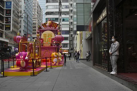 A shop assistant wearing a face mask, waits for customer at a shop in Hong Kong, Friday, Jan. 28, 2022. (Photo | AP)