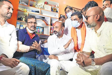 BJP leaders Bandi Sanjay Kumar, Dharmapuri Arvind and Raghunandan Rao console a BJP worker who was injured in the attack, in Nizamabad on Thursday