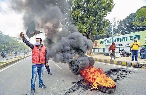 RJD workers block road during the Bihar bandh called in connection with railway recruitment, in Patna on Friday | PTI