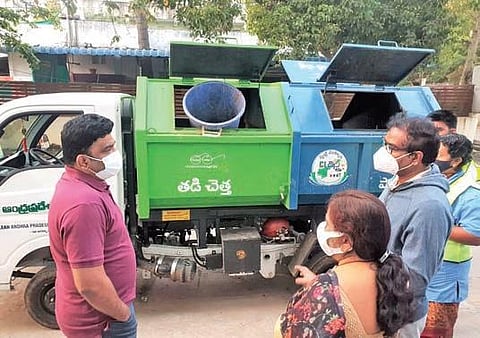 VMC Commissioner P Ranjith Basha interacts with workers in Vijayawada on Friday | Express