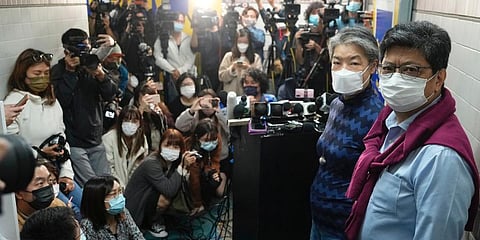 Citizen News' founder and chief writer Chris Yeung, right, and chief editor Daisy Li, second right, pose before a press conference outside their office in Hong Kong. (Photo | AP)