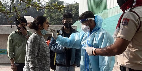 A health worker takes a swab sample for COVID-19 test in New Delhi on Saturday. (Photo | Parveen Negi, EPS)
