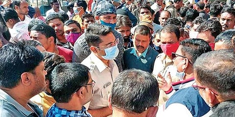 Police and irate villagers holding discussions at the protest site in Jharpokharia. (Photo | EPS)