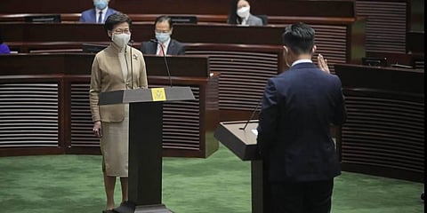 Newly elected pro-Beijing lawmaker Vincent Cheng Wing-shun, right, takes his oath in front of Chief Executive Carrie Lam. (Photo | AP)