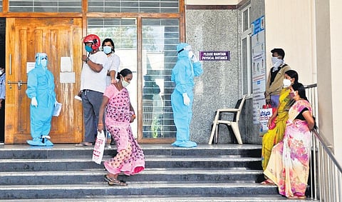 Family members of patients wait outside the Covid ward of King George Hospital in Visakhapatnam on Saturday | G Satyanarayana